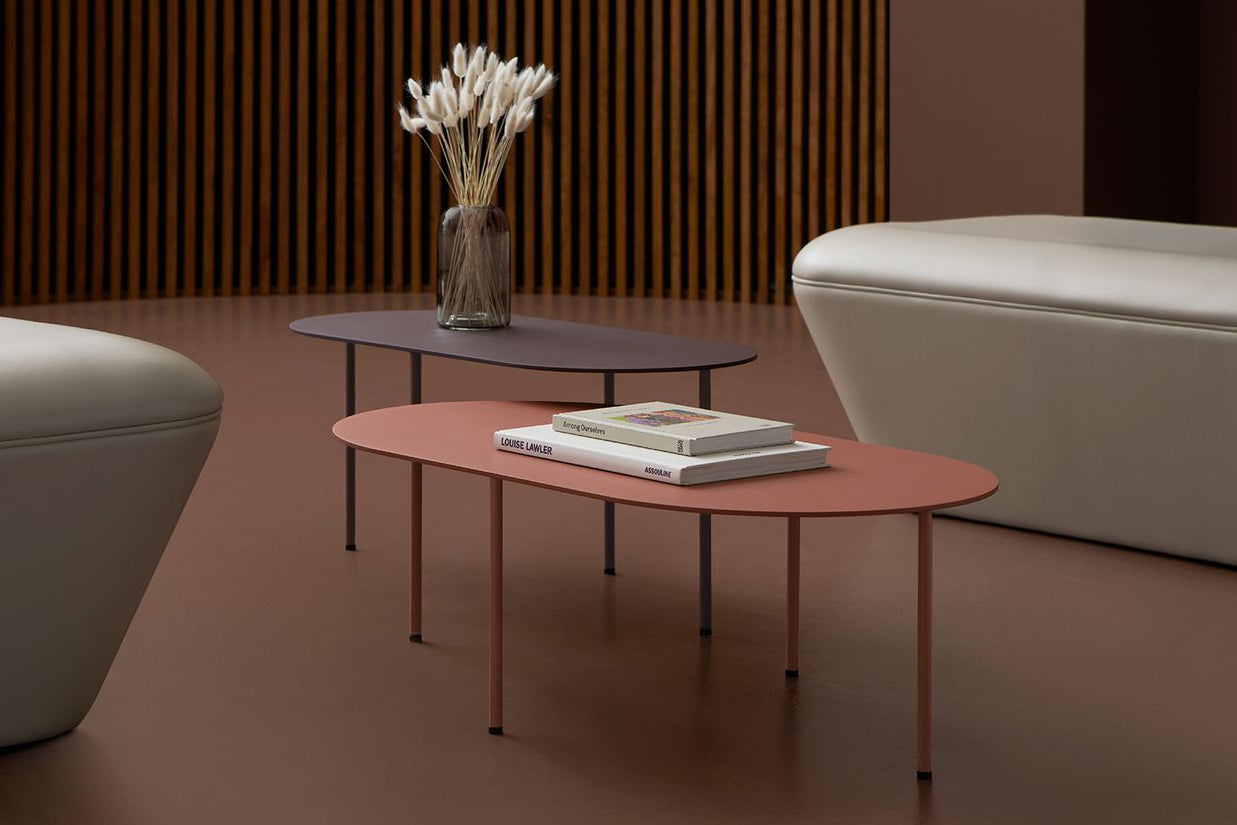 Modern living room with white sofa, coffee table, and decorative elements.